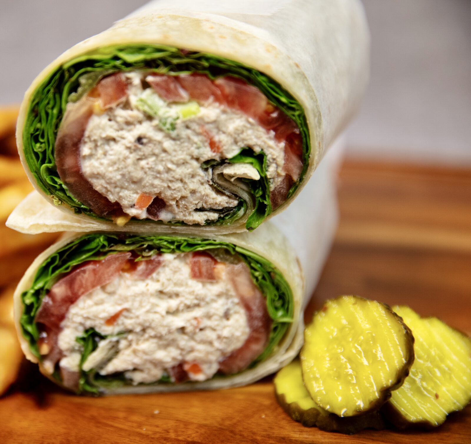 Classic tuna wrap sliced in half with pickles